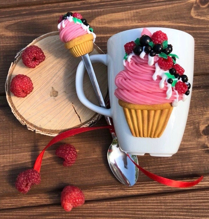 Sweet cupcake with berries on a mug, sweet spoon with cupcake, ice cream spoon, tea mug with decor, decorated mug, gift mug. Pink, White.