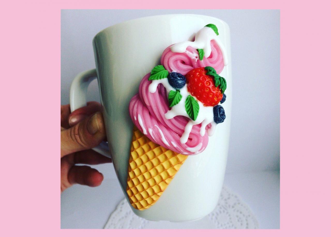 White mug with decor, sweet ice cream with berries. Decorated mug as a gift, decorated mug